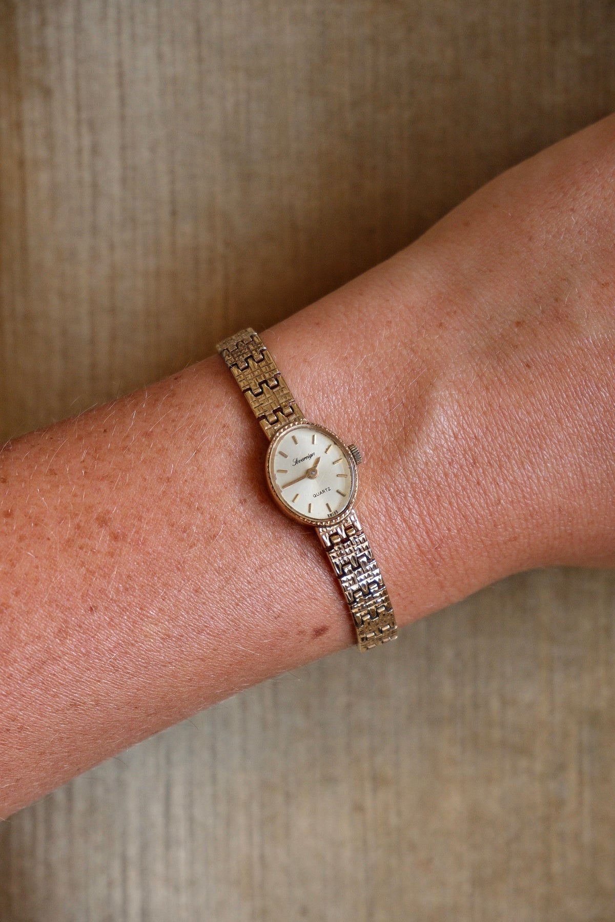 1980s Vintage 9ct Yellow Gold Sovereign quartz dress watch with an oval case and a textured link bracelet