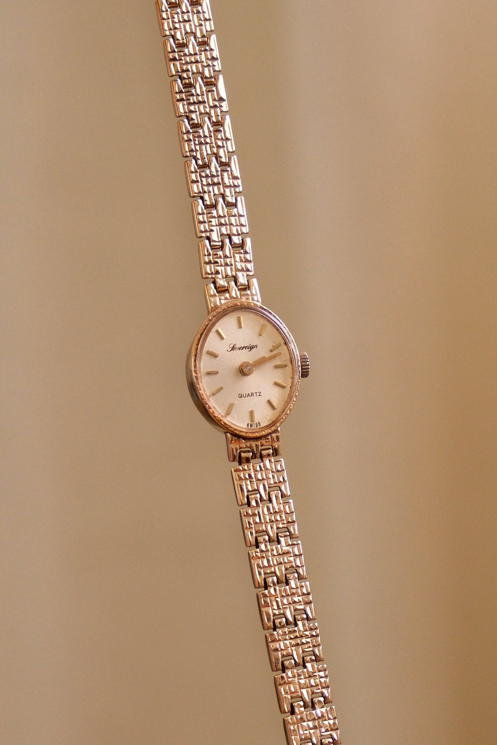 1980s Vintage 9ct Yellow Gold Sovereign quartz dress watch with an oval case and a textured link bracelet