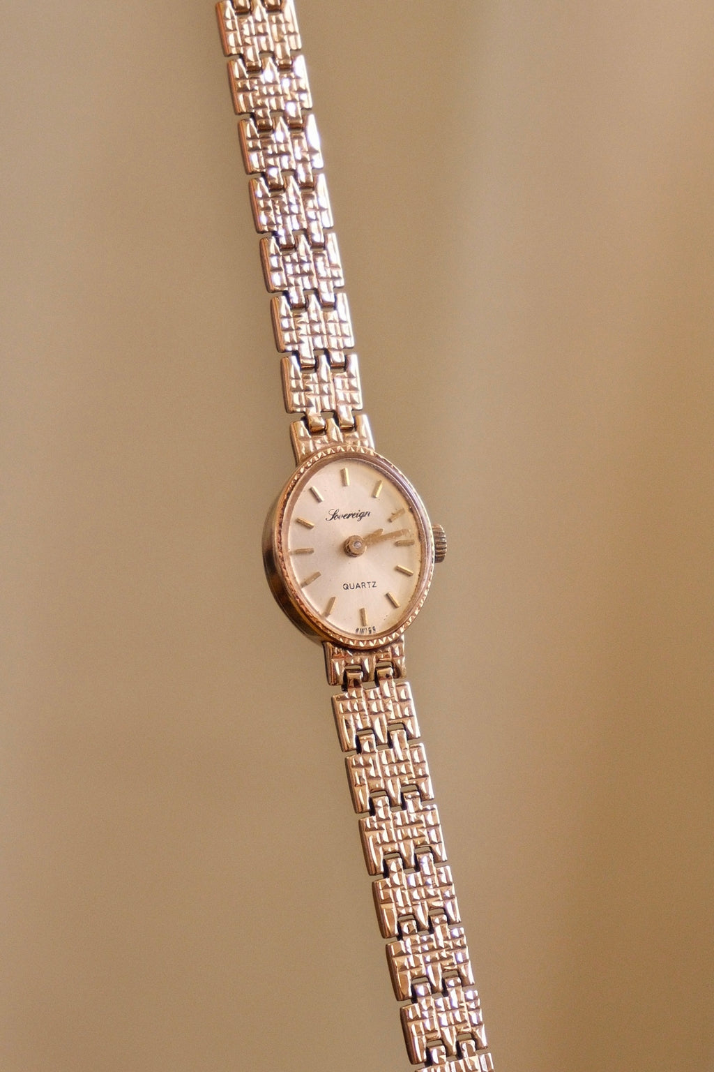 1980s Vintage 9ct Yellow Gold Sovereign quartz dress watch with an oval case and a textured link bracelet