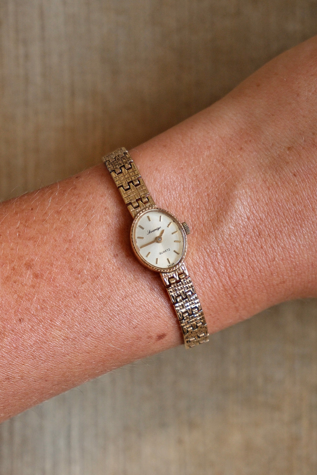 1980s Vintage 9ct Yellow Gold Sovereign quartz dress watch with an oval case and a textured link bracelet