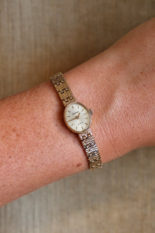 1980s Vintage 9ct Yellow Gold Sovereign quartz dress watch with an oval case and a textured link bracelet